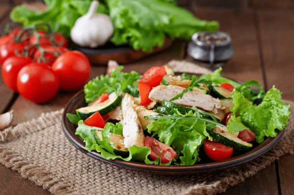 A salad with chicken and vegetables is a great option for a light dinner after a workout. 