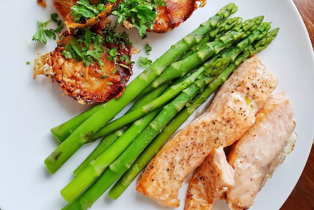 Fried fish with asparagus on a low-carb diet menu