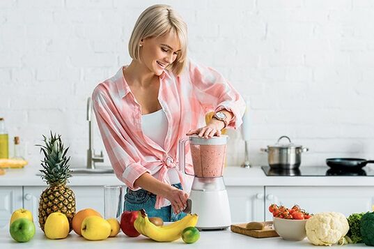 girl in a blender is preparing a smoothie for weight loss